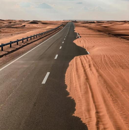 Desert highway with drifting sand